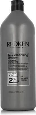 A gray bottle of Redken Hair Cleansing Cream Shampoo.