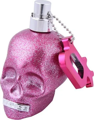 A pink glittery skull-shaped perfume bottle with a silver cap and a pink keychain accessory.