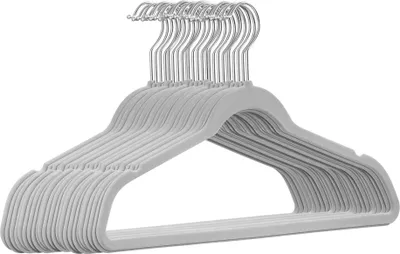 A stack of light grey velvet hangers with silver hooks.