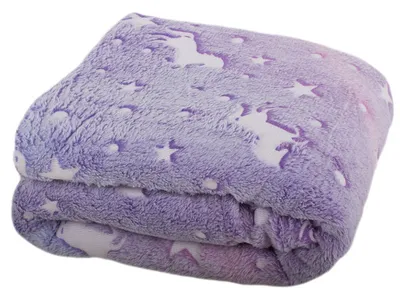 A folded blanket with a unicorn and star pattern.
