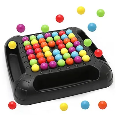 A colorful board game with many small balls arranged on a black board, with some balls scattered around the board.