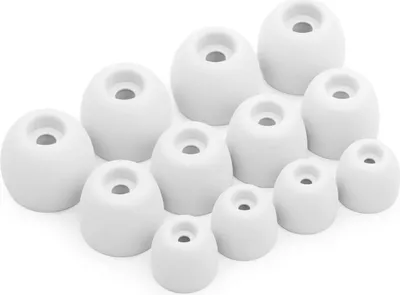 A collection of white silicone earbud tips of various sizes arranged on a white background.