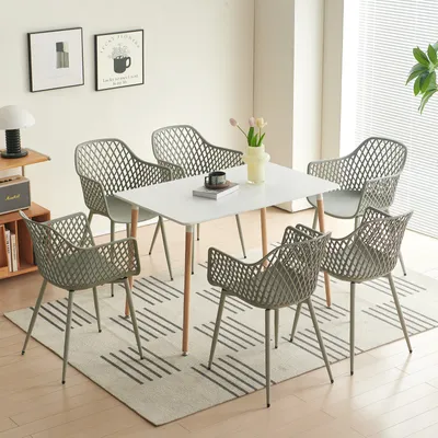 A dining set with a white table and six gray chairs arranged on a rug in a well-lit room.