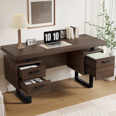 A modern home office setup featuring a dark wood desk with black metal legs, a laptop, a lamp, and decorative items.