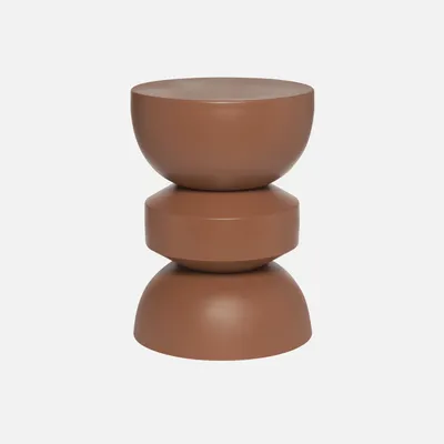 A terracotta-colored side table with a stacked, geometric design.
