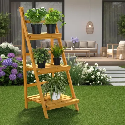 A wooden plant stand with three tiers, filled with various potted plants, is set up on a green lawn in a backyard. In the background, there is a patio with outdoor furniture and landscaping.