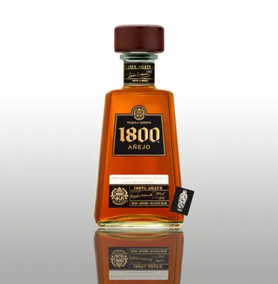 A bottle of 1800 Añejo Tequila is shown against a white and gray gradient background, with its reflection visible below.