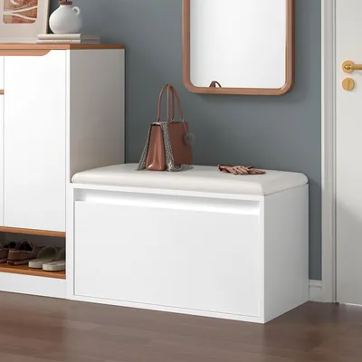 An entryway with a shoe cabinet and a bench.