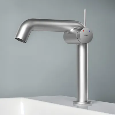 A modern, brushed metal faucet is shown against a plain gray background, positioned over the edge of a white sink.