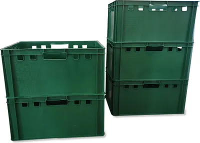 A stack of green plastic crates on a white background.