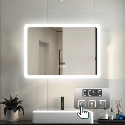 A modern bathroom sink area with a lit mirror and a digital control panel.