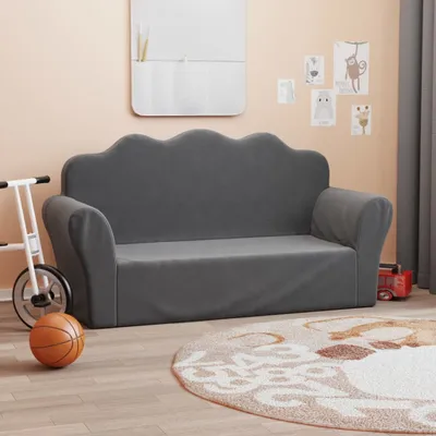 A child's sofa in a room with toys and decorations.