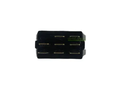 A close-up of a black electrical connector with gold-colored pins.