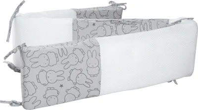 A baby crib bumper with a Miffy bunny pattern.