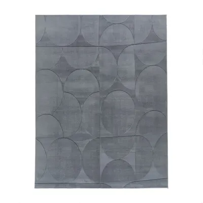 A gray rug with a geometric pattern of circles and squares.