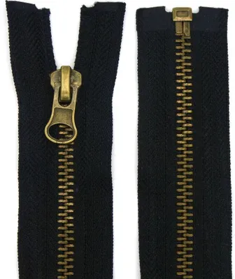Two parts of a black zipper with bronze-colored teeth and pull tab are shown against a white background.