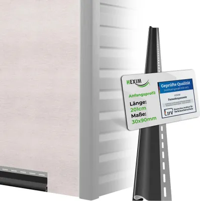 A close-up view of a white siding panel with a black starter strip at the bottom, and a marketing tag with product details and certifications attached to a dark, textured object resembling a road or track.