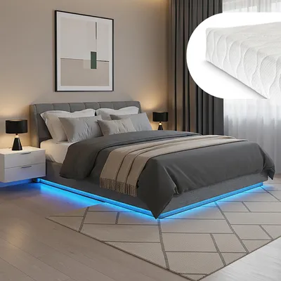 A bedroom scene featuring a bed with LED lighting.