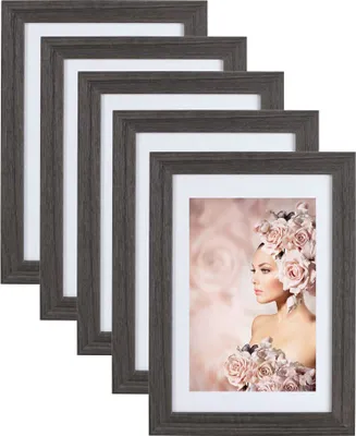 A stack of five gray picture frames, with one frame in the foreground displaying a portrait of a woman adorned with flowers.