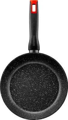 A black frying pan with a speckled interior and a black handle with a red accent is shown against a white background.