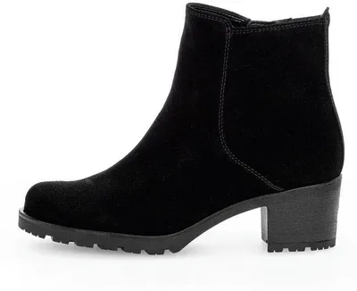 A black suede boot with a block heel is shown from the side against a white background.