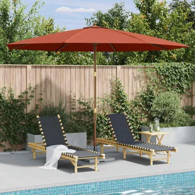 Two lounge chairs and a table are set up next to a swimming pool, under a large umbrella.