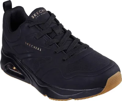 A black Skechers sneaker with a brown sole, shown from a side-angle on a white background.