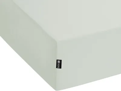 A close-up view of a light green fitted sheet, showing its texture and a small black label with white text.