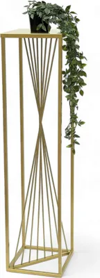 A gold metal plant stand with a potted plant on top.