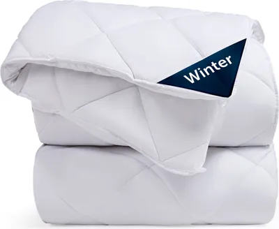 A folded white winter duvet is shown, with a dark blue tag indicating 'Winter'.