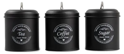 Three black storage canisters for tea, coffee, and sugar, arranged side-by-side.