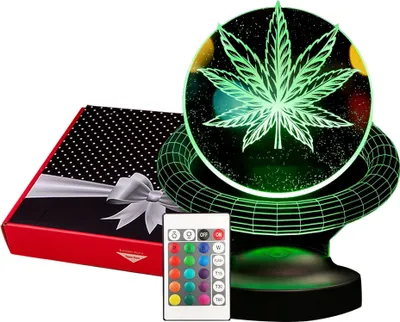 A cannabis leaf-shaped LED lamp with a remote control and a gift box.