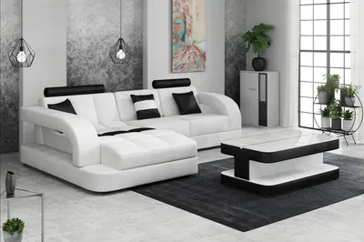 A modern living room with a white and black sectional sofa and a matching coffee table.