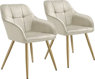 Two cream-colored chairs with gold legs are shown against a white background.