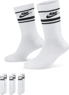 A pair of white Nike crew socks with black stripes and logo, and a stack of similar socks below.