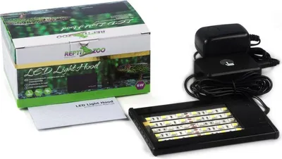 A product box, instruction manual, and LED light hood with its power adapter are displayed.