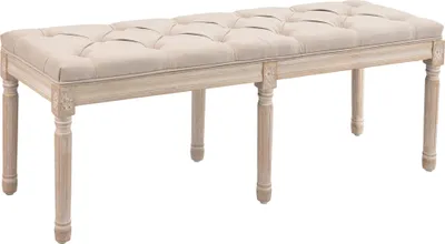 A beige upholstered bench with tufted detailing and carved wooden legs, presented against a white background.