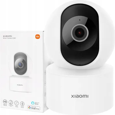 A white Xiaomi smart camera and its packaging are displayed against a white background.