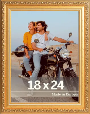 A couple on a motorcycle in a desert landscape.