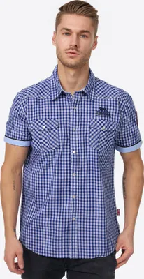 A man wearing a blue checkered short-sleeved shirt.