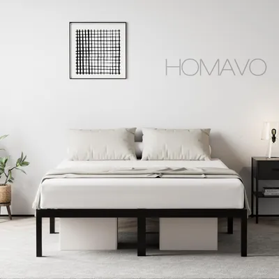 A minimalist bedroom scene featuring a black metal bed frame with white bedding and pillows, a framed abstract artwork on the wall, and a bedside table with a lamp.