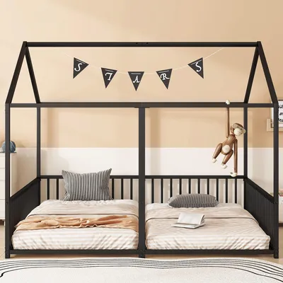 A black metal house-shaped bunk bed with two twin-sized mattresses, decorated with a banner that spells 'STARS' and a hanging monkey toy.