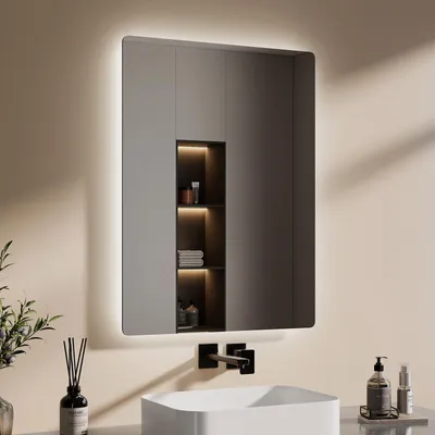 A modern bathroom vanity with a lit mirror and sink.