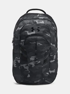 A black and gray camouflage backpack with the Under Armour logo and name.