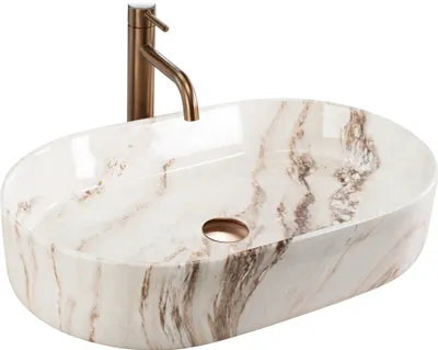 A white oval countertop sink with a marble-like pattern and a bronze faucet.