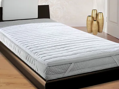 A mattress topper on a bed in a bedroom setting.