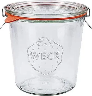 A clear glass Weck jar with an orange rubber seal and metal clips, shown against a white background.