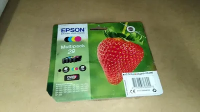 The image shows the packaging of an Epson multipack of ink cartridges, featuring a strawberry graphic.