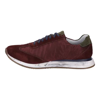 A side view of a single red sneaker against a white background.