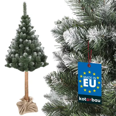 A close-up view of a frosted artificial Christmas tree with a tag attached.